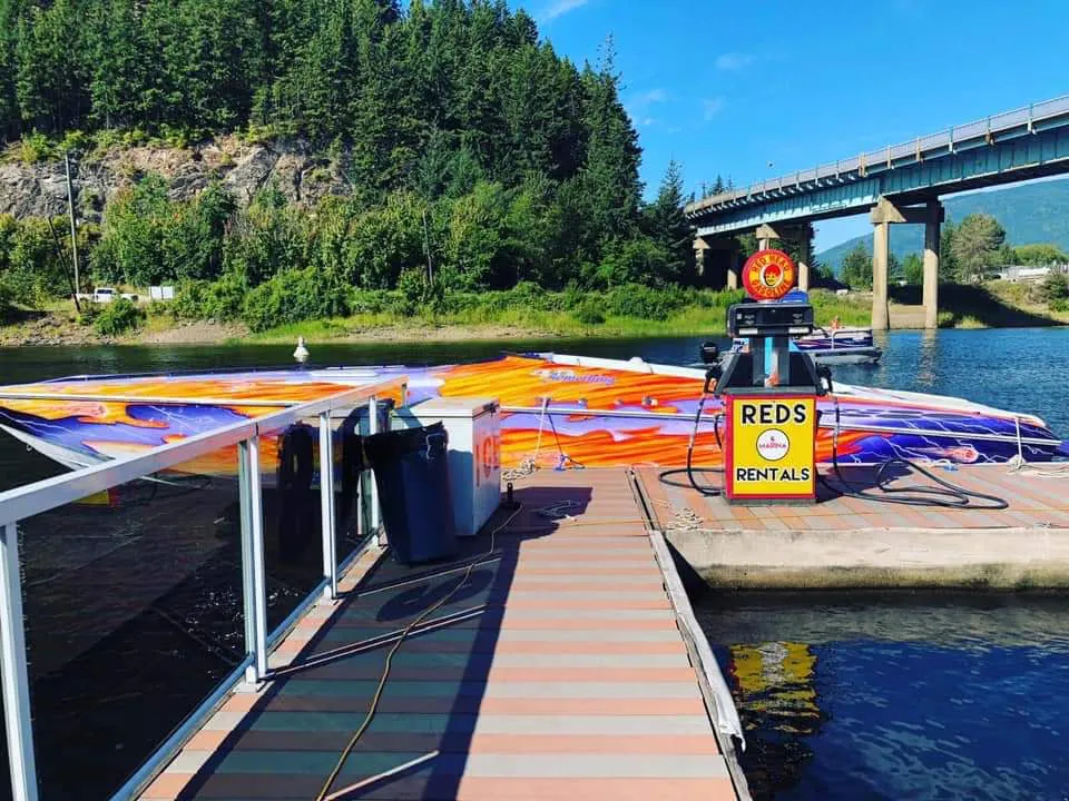 Red's Rentals dock and boats on the Sicamous channel under the Highway 1 bridge